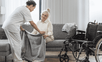 Doctor Taking Care Senior Woman Home